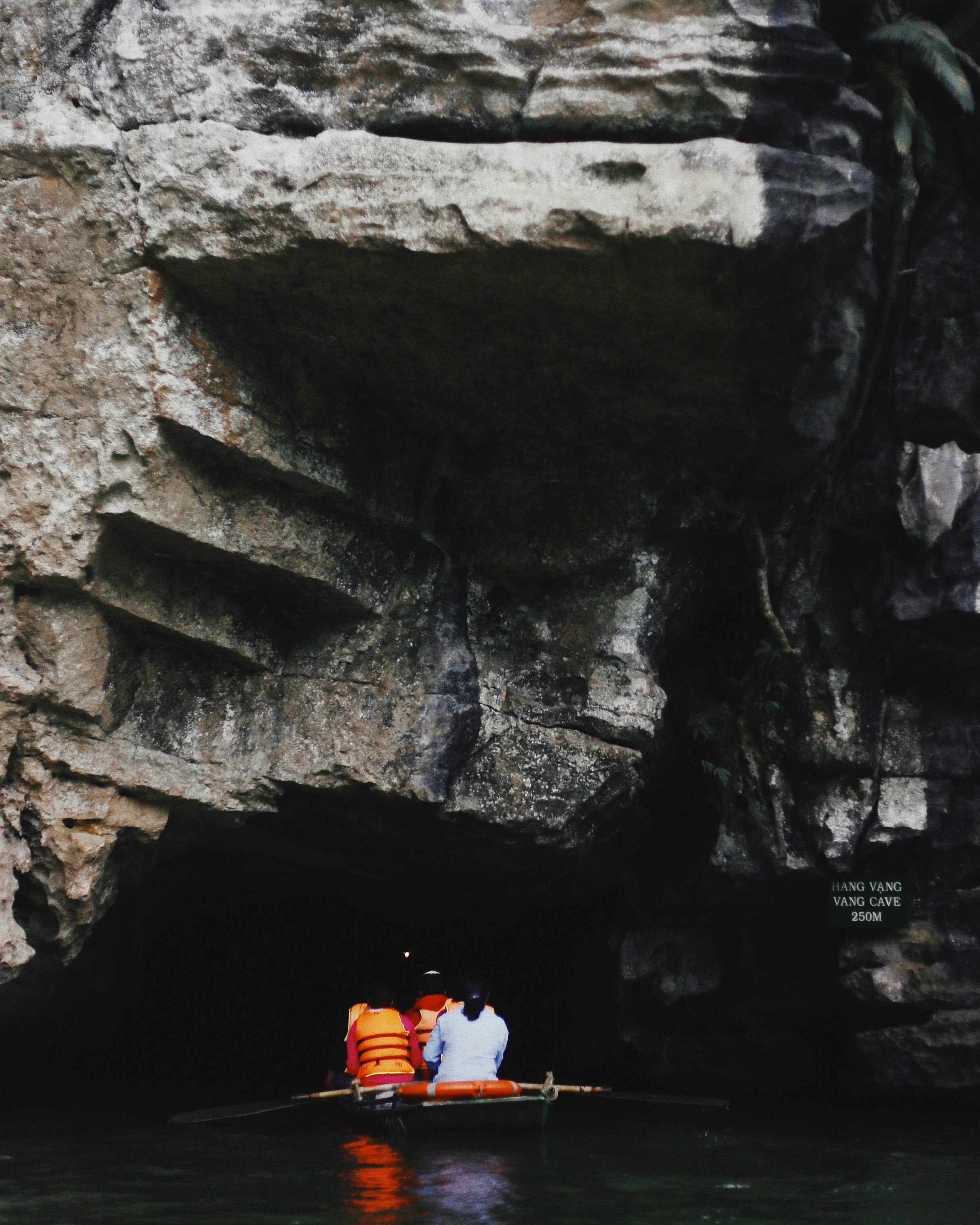 group of people on a boat going in a cave